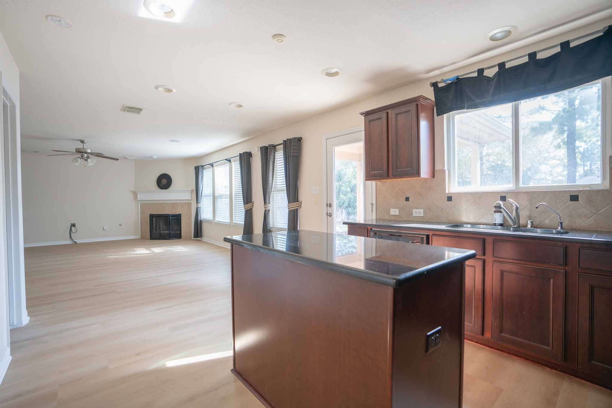 6403 Lost Timber Lane Houston, TX 77066 - Photo 15 of 34 a kitchen with granite countertop a sink and a stove top oven