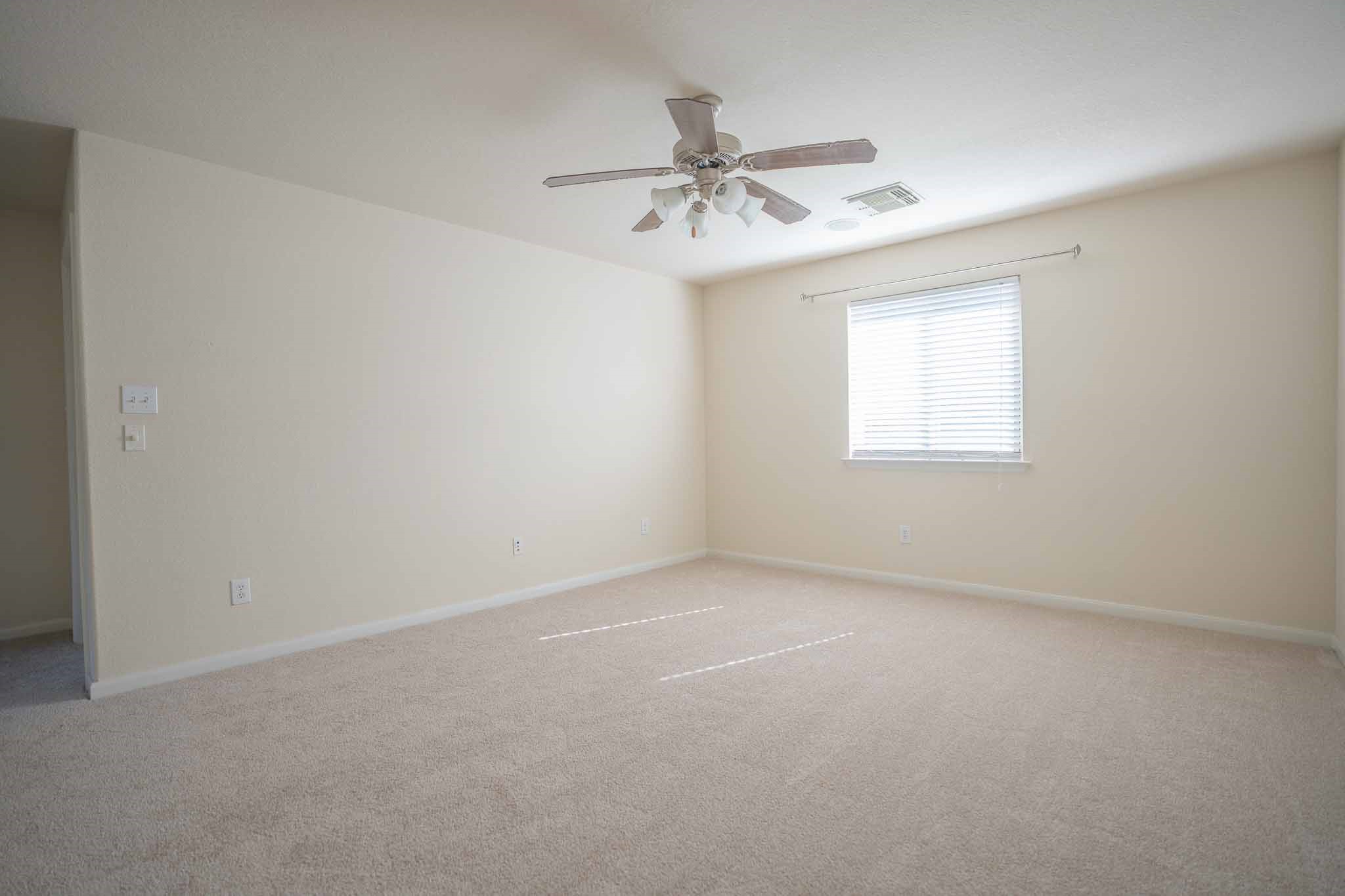 6403 Lost Timber Lane Houston, TX 77066 - Photo 24 of 34 an empty room with windows and fan