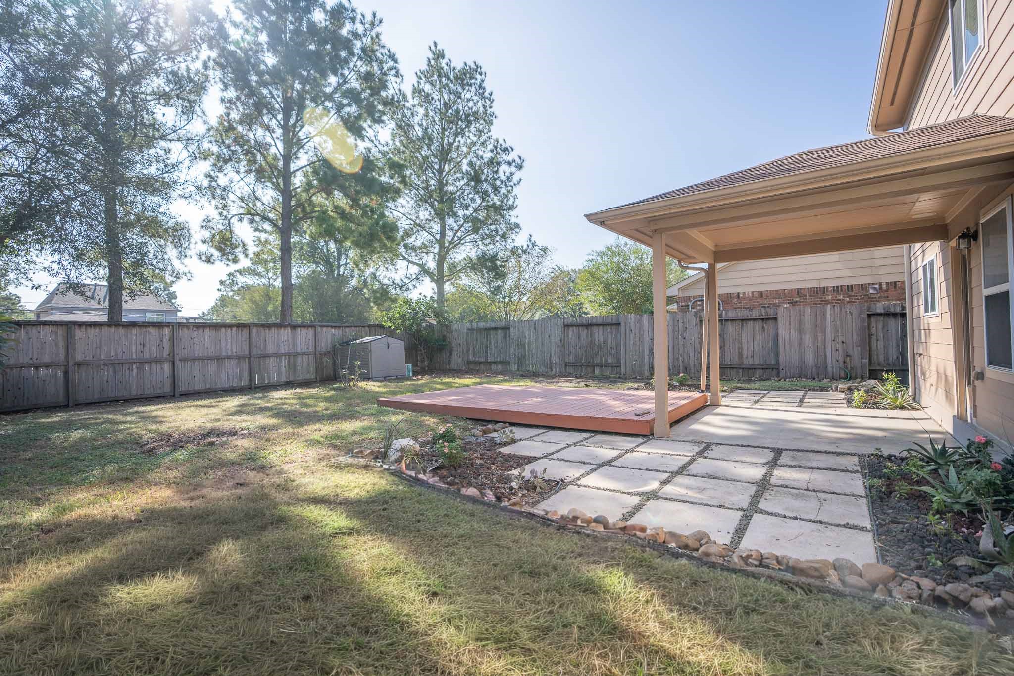 6403 Lost Timber Lane Houston, TX 77066 - Photo 31 of 34 a view of a backyard with large trees and wooden fence