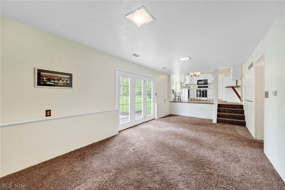8451 Valley View Road Macedonia, OH 44056 - Photo 19 of 31 Unfurnished family room with a textured ceiling and French doors to patio