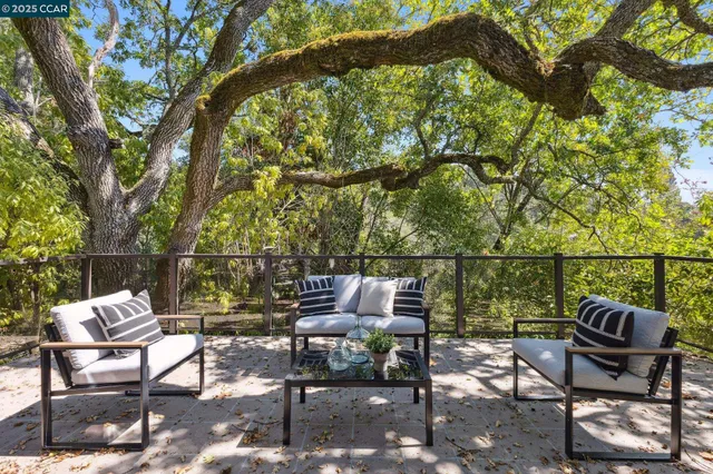 a view of a chairs and table in the back yard