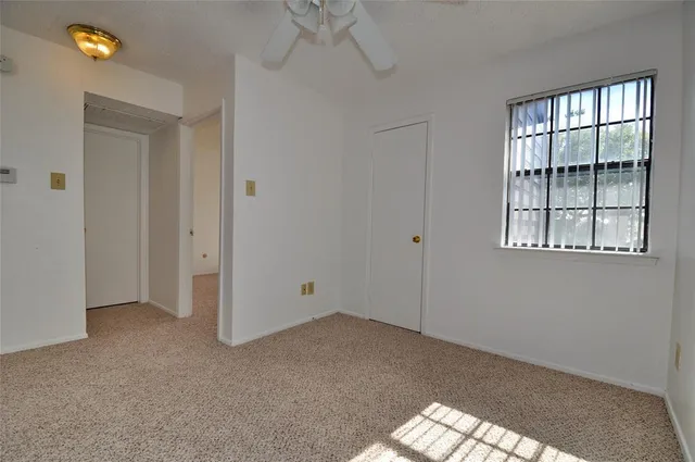 a view of empty room with a fan