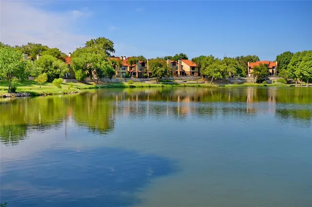 a view of a lake with houses in the back