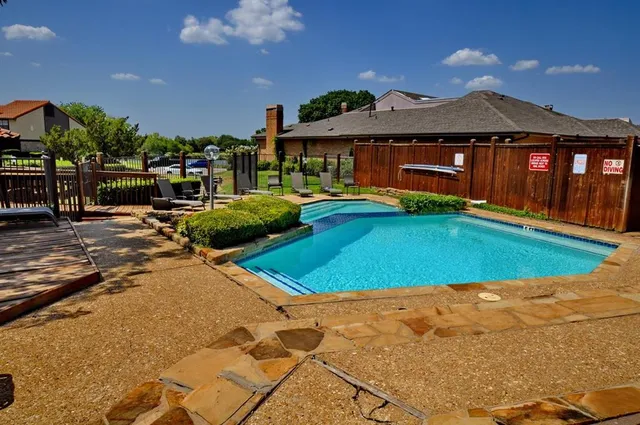 a view of a chairs and table in the patio with a fire pit