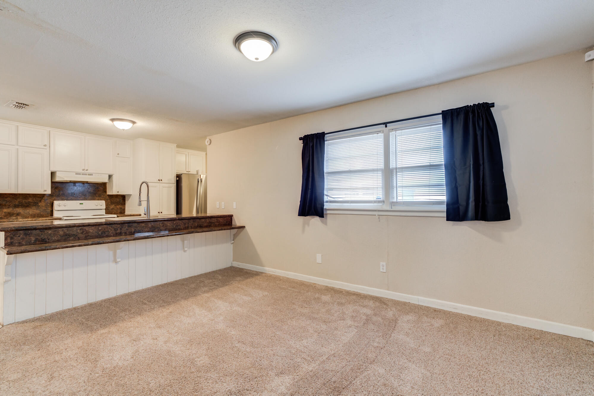 403 East 19th Street Littlefield, TX 79339 - Photo 13 of 34 an empty room with windows