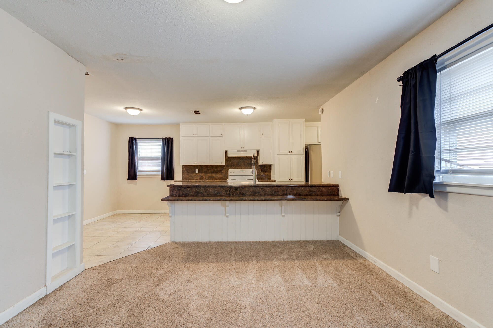 403 East 19th Street Littlefield, TX 79339 - Photo 14 of 34 a view of kitchen with stainless steel appliances wooden floor and windows