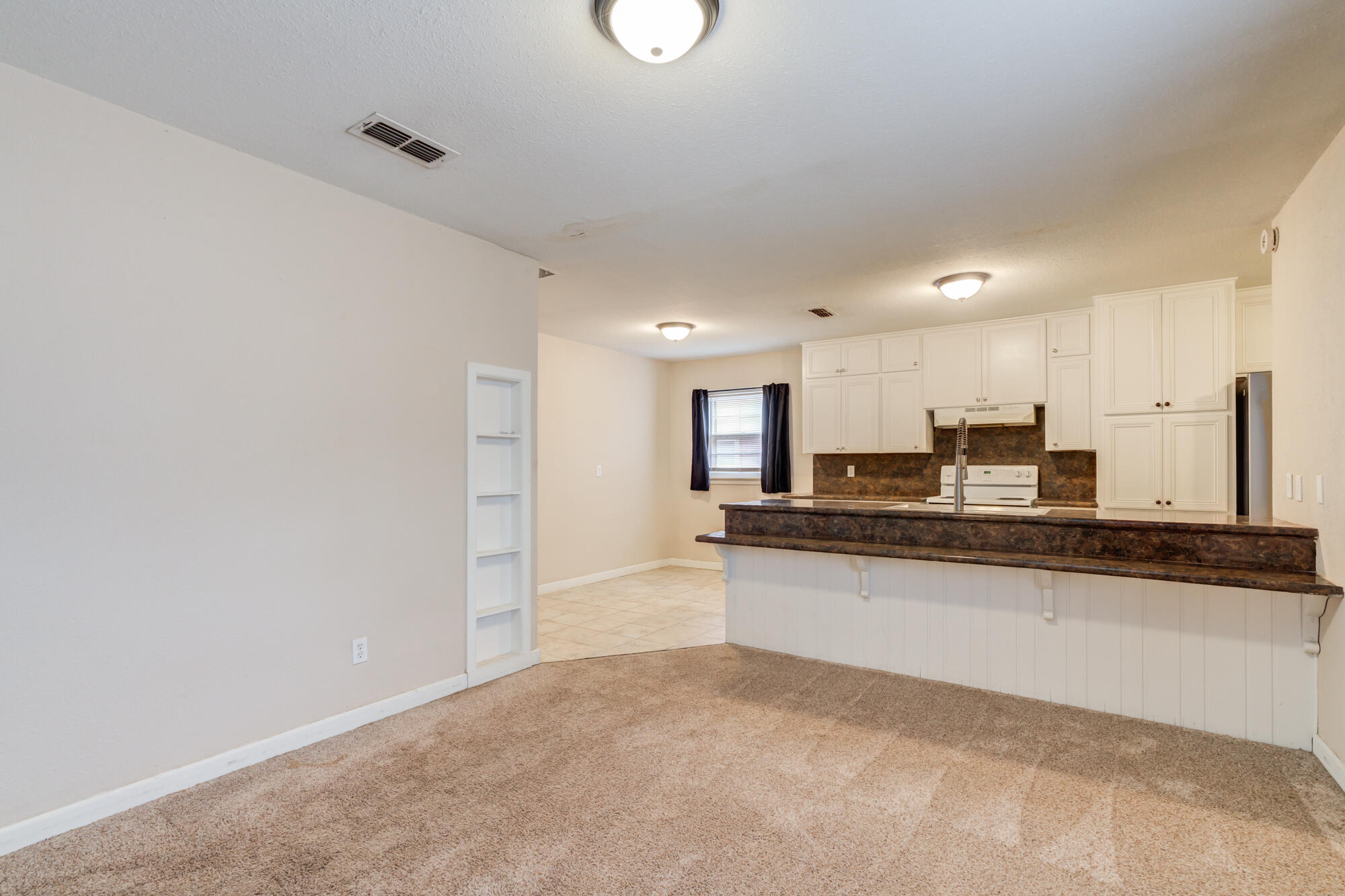 403 East 19th Street Littlefield, TX 79339 - Photo 15 of 34 a large kitchen with stainless steel appliances a large counter top a stove and a refrigerator