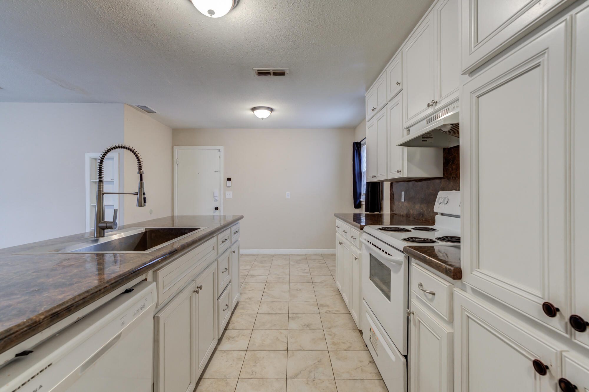 403 East 19th Street Littlefield, TX 79339 - Photo 23 of 34 a kitchen with stainless steel appliances granite countertop a sink and cabinets