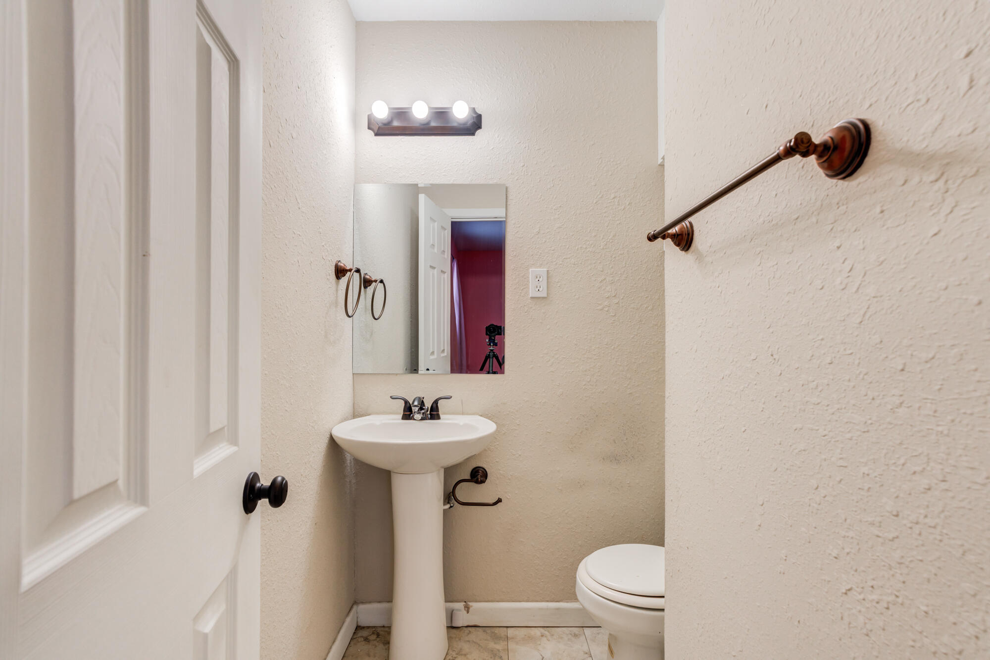 403 East 19th Street Littlefield, TX 79339 - Photo 26 of 34 a bathroom with a sink a toilet and shower curtain
