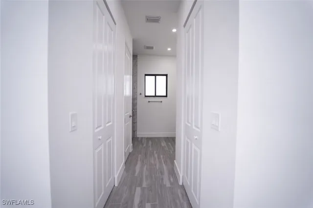 a view of a hallway with wooden floor
