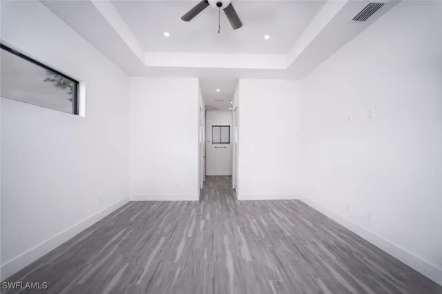 a kitchen that has a stove and a wooden floor