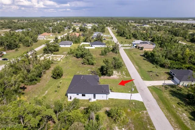 an aerial view of residential house with outdoor space and swimming pool