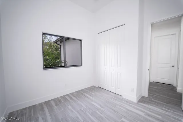 an aerial view of a house with swimming pool and mountains