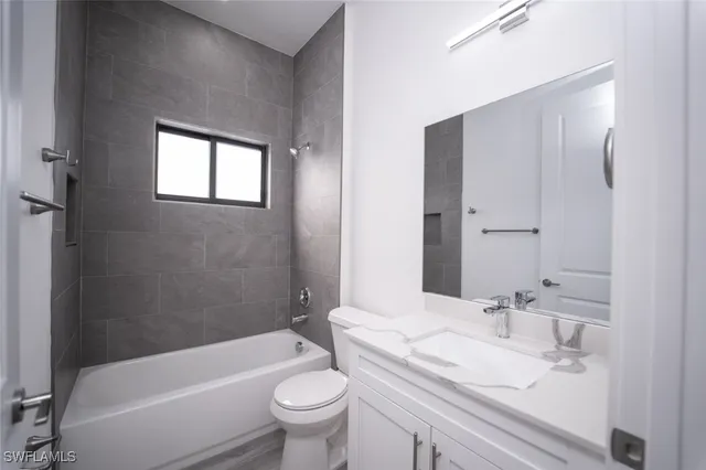 a bathroom with a toilet a sink and bathtub