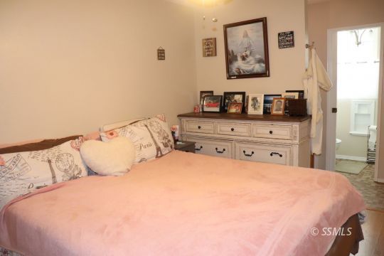 1624 South Farragut Street Ridgecrest, CA 93555 - Photo 24 of 43 a bedroom with a bed and a lamp on dresser