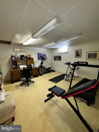 a room with gym equipment and a view of living room
