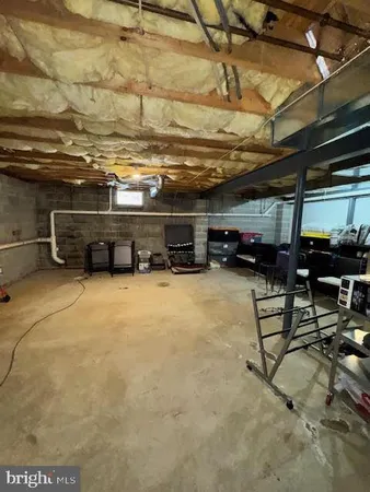 a spacious bedroom with a bed and a flat screen tv