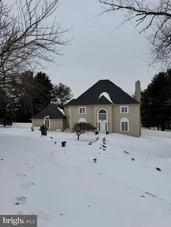 a view of a house with a yard covered in snow