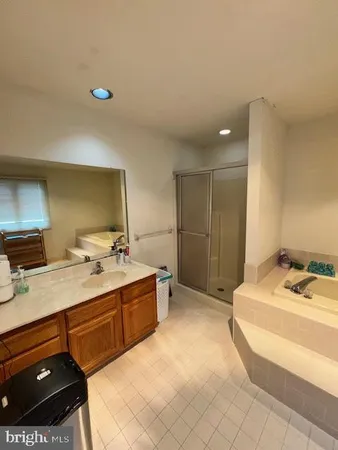 a spacious bathroom with a tub and shower