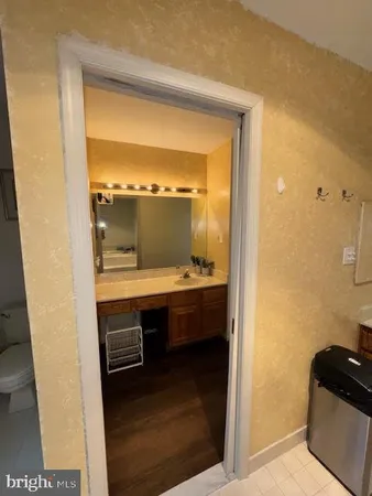 a bedroom with a large bed and a flat tv screen on dresser