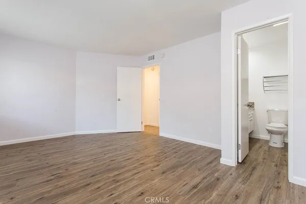 a bathroom with a granite countertop toilet sink and mirror