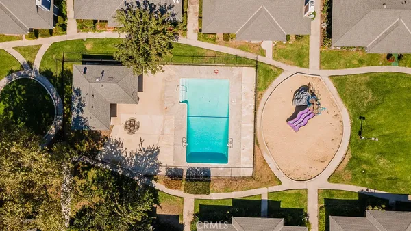 an aerial view of residential houses with yard