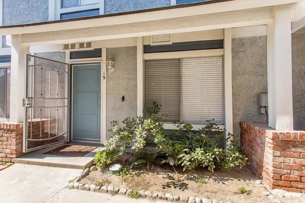 a outdoor view of a building with potted plants