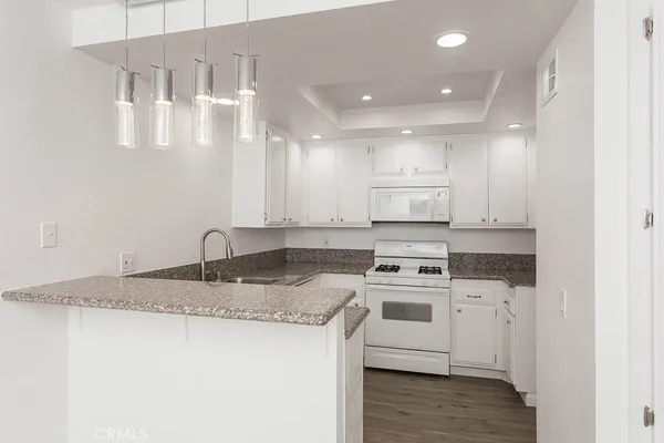 a kitchen with cabinets appliances and a sink