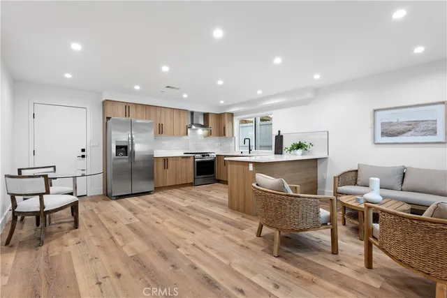 a kitchen with stainless steel appliances kitchen island granite countertop a sink and cabinets