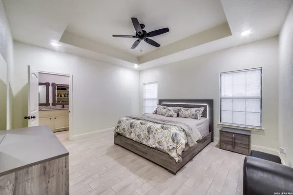 a bedroom with a large bed and a chandelier