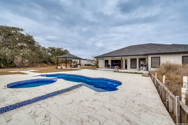a house with swimming pool in front of it