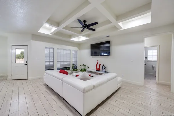 a living room with hard wood floor furniture and a flat screen tv