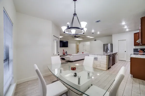 a dining room with furniture and a chandelier