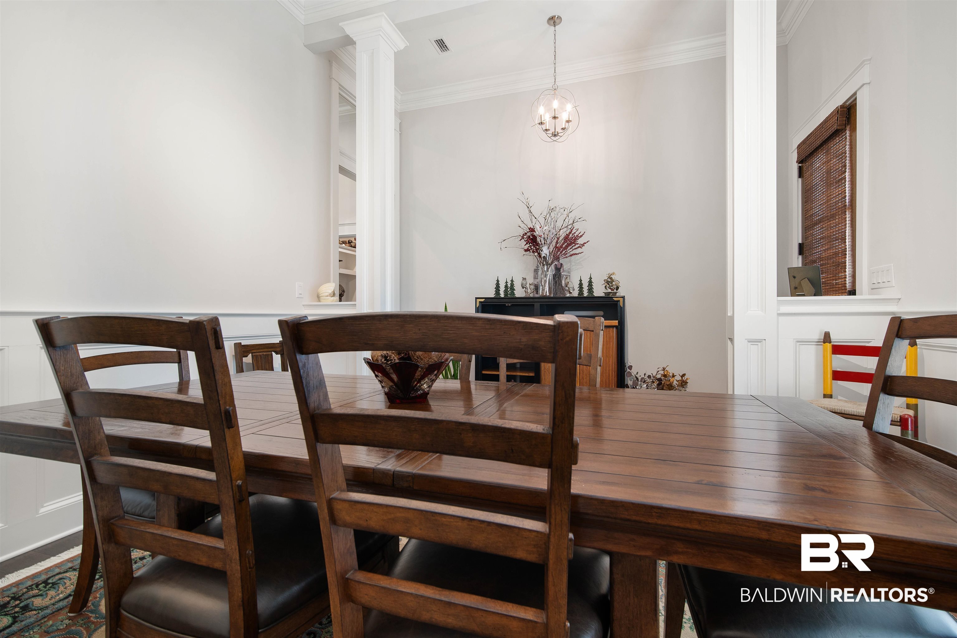 969 Charleston Loop Fairhope, AL 36532 - Photo 14 of 30 Dining area featuring decorative columns, ornamental molding, and an inviting chandelier