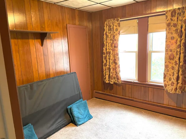 a living room with a bed and a window