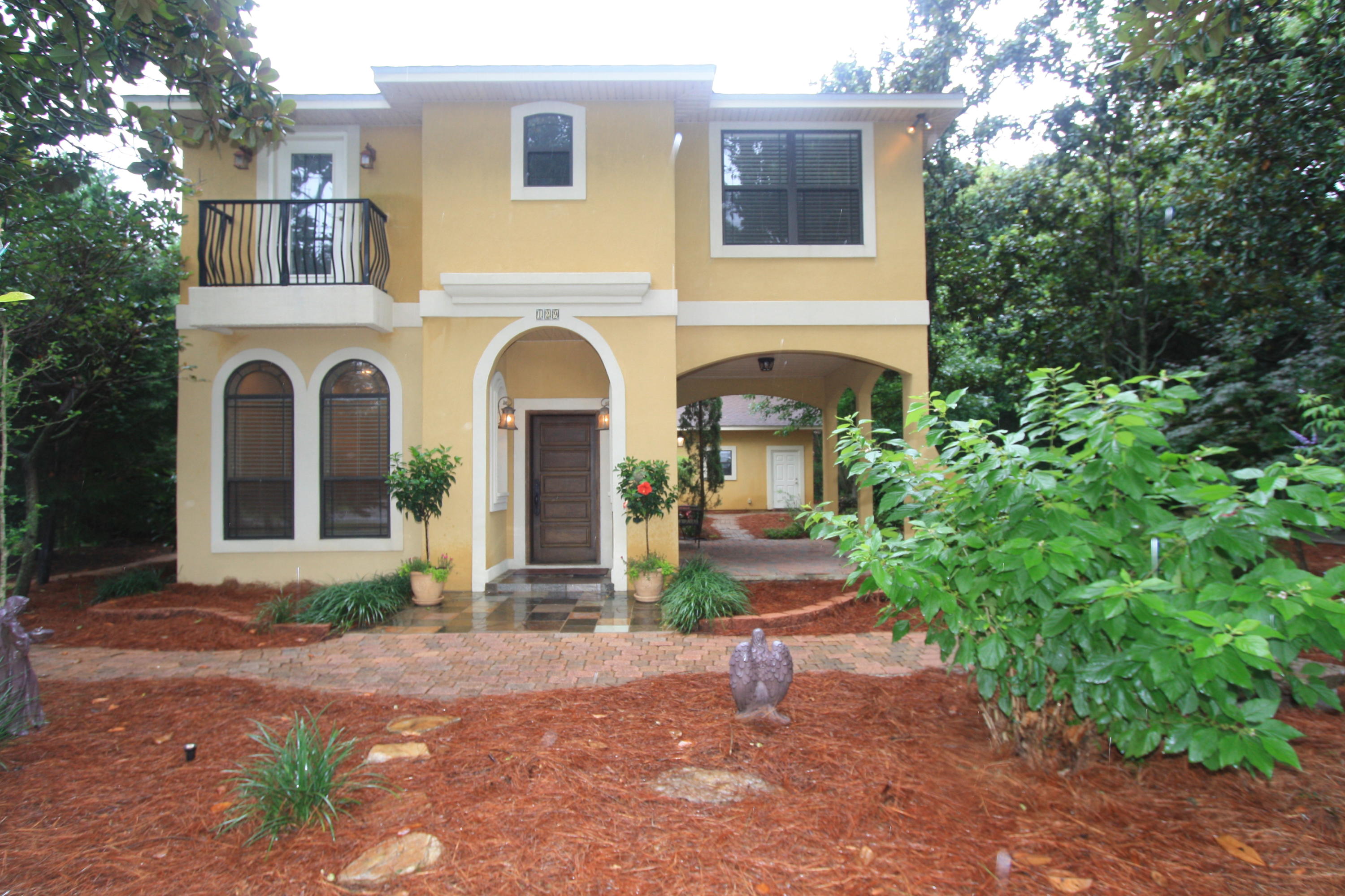 129 Walton Way Miramar Beach, FL 32550 - Photo 1 of 29 a front view of a house with garden