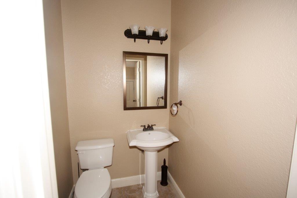 129 Walton Way Miramar Beach, FL 32550 - Photo 18 of 29 a bathroom with a toilet sink and mirror