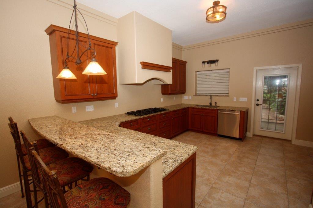 129 Walton Way Miramar Beach, FL 32550 - Photo 2 of 29 a kitchen with stainless steel appliances granite countertop a sink dishwasher and a wooden cabinets