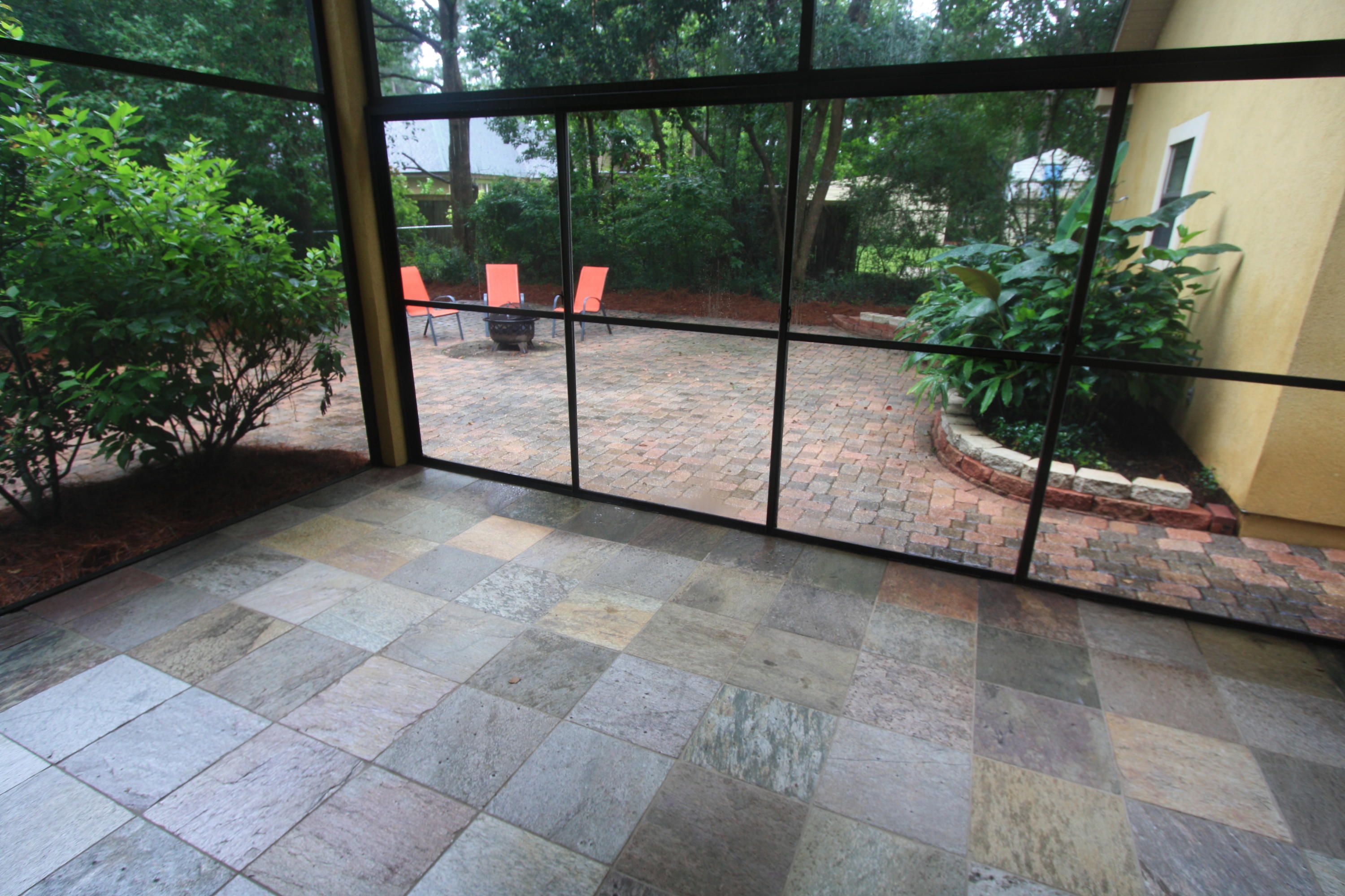 129 Walton Way Miramar Beach, FL 32550 - Photo 21 of 29 a view of a porch with a floor to ceiling window next to a yard