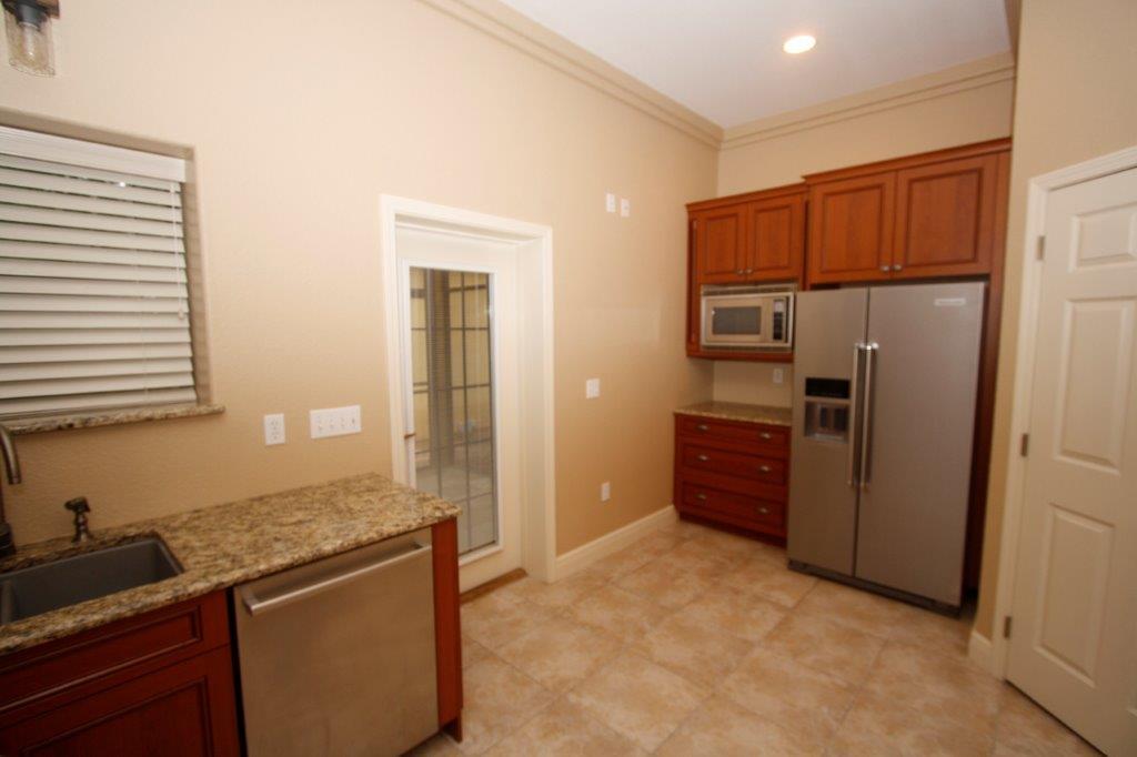 129 Walton Way Miramar Beach, FL 32550 - Photo 3 of 29 a kitchen with stainless steel appliances granite countertop a refrigerator and a sink