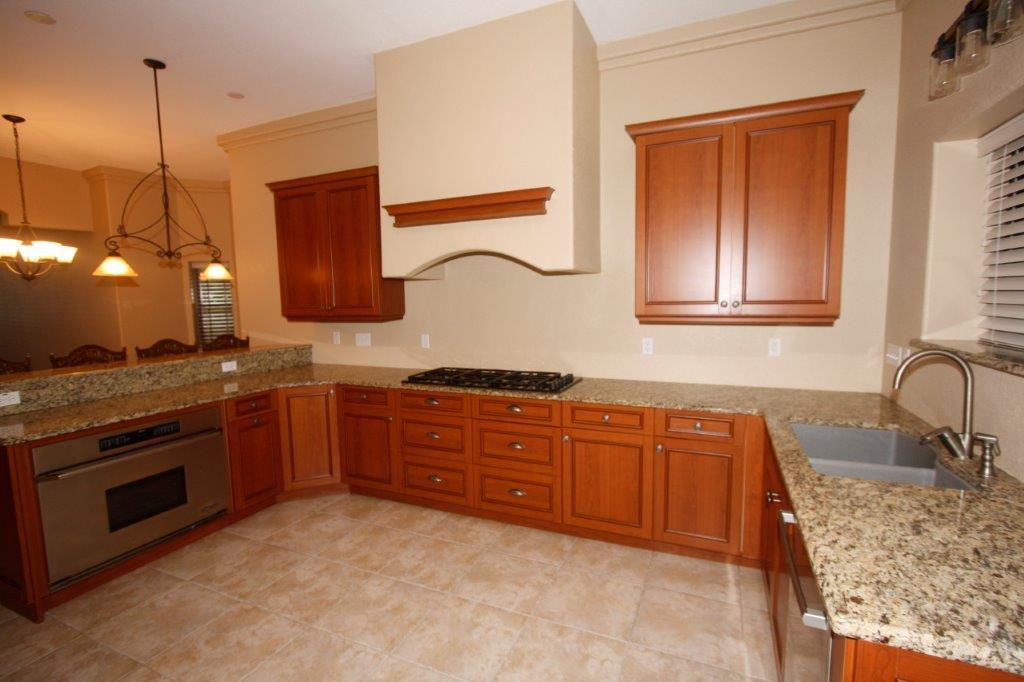 129 Walton Way Miramar Beach, FL 32550 - Photo 8 of 29 a kitchen with stainless steel appliances granite countertop a sink a stove and a microwave