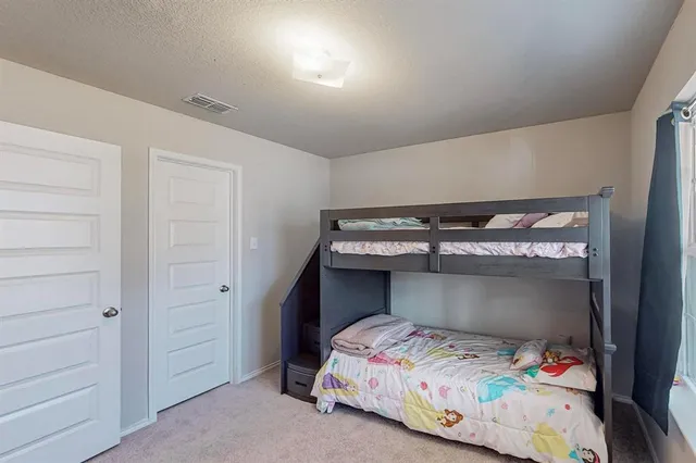 a bedroom with a bed and a closet