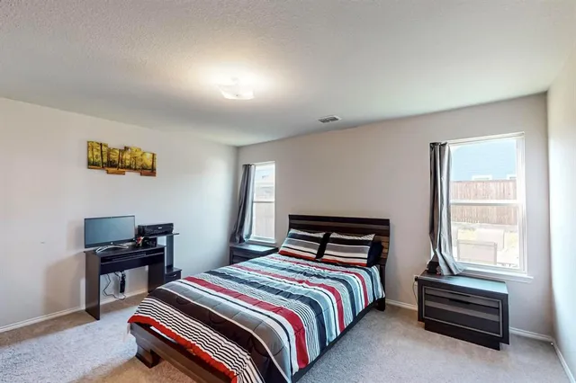 a bedroom with a bed and a desk