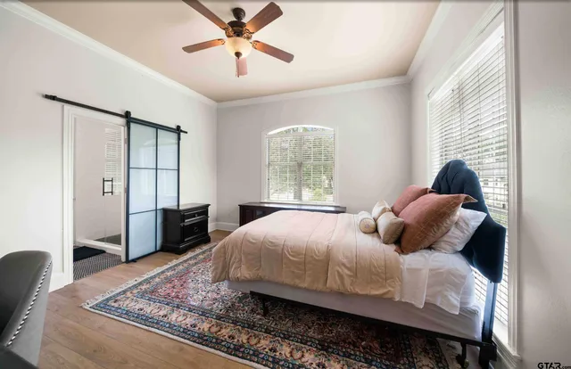 a bedroom with a large bed and a chandelier