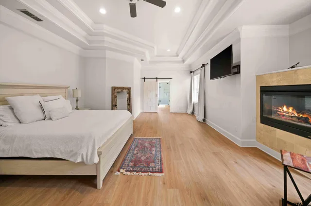 a spacious bedroom with a bed and a television