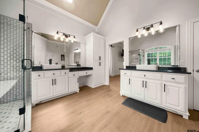 a large bathroom with a double vanity sink mirror and