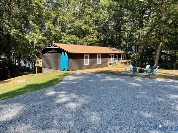 a front view of a house with a yard and trees