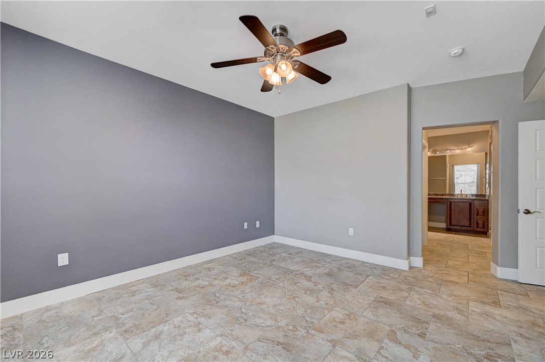 2555 Hampton Road, Unit 6108 Henderson, NV 89052 - Photo 21 of 63 Unfurnished room with ceiling fan and light stone finish flooring