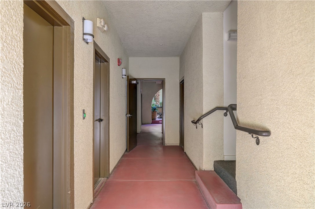 2555 Hampton Road, Unit 6108 Henderson, NV 89052 - Photo 33 of 63 Hallway featuring a textured ceiling and a textured wall