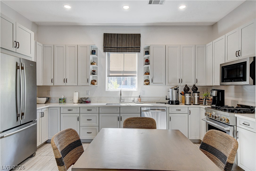 2555 Hampton Road, Unit 6108 Henderson, NV 89052 - Photo 55 of 63 Kitchen with stainless steel appliances, open shelves, white cabinetry, recessed lighting, and light stone counters